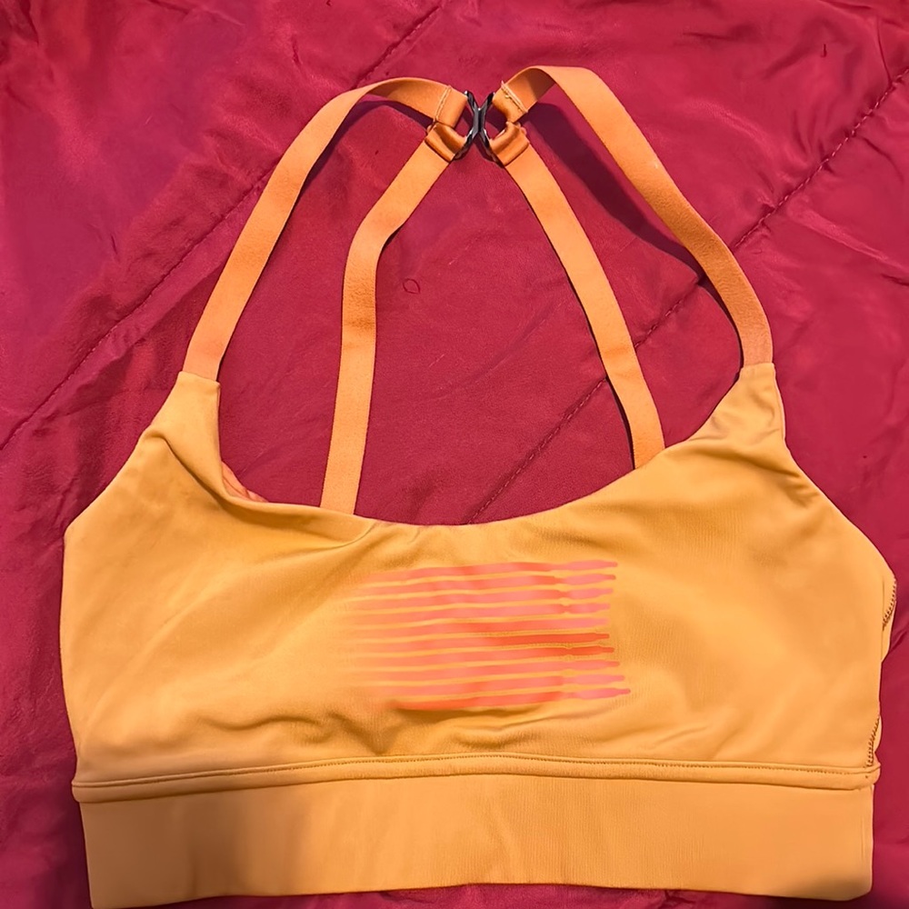 Yellowish orange color sports bra from savage X Fenty